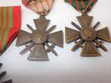 two medals are sitting on a table with ribbons around them