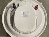 a white toilet with the lid up on the floor