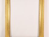 an empty picture frame sitting on top of a white shelf
