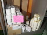 several rolls of toilet paper are stacked on a shelf in a room