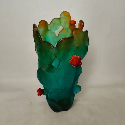 a glass vase with a cactus plant inside of it