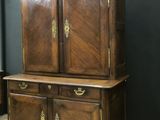 a large wooden cabinet with two doors on top of it