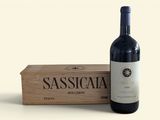 a bottle of wine sitting next to a wooden box