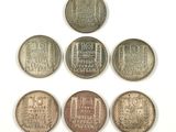 six different types of coins on a white surface