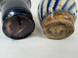 two salt and pepper shakers sitting next to each other