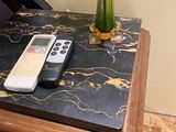 a remote control sitting on a table next to a vase of flowers