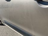 the door handle of a silver car with the door handle missing
