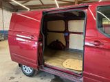 a red van with its doors open in a garage