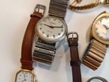 a lot of watches that are sitting on a table
