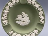 an image of a green plate with a picture of a man on a horse on it