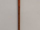 a wooden stick that is leaning against a wall