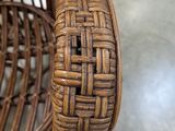 a wicker chair with a woven seat and back