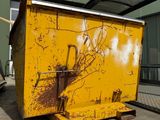 a yellow dumpster that is sitting in front of a building