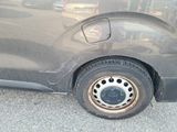 a car that has a flat tire on the side of the road