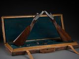 deux armes à feu qui se trouvent dans un étui posé sur une table