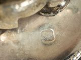 a close up of a silver plate with a ring on it