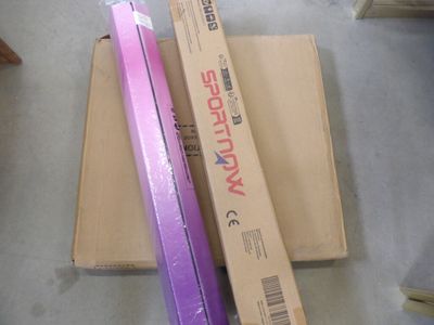 two pink and purple toothbrushes sitting on top of a cardboard box