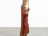 a statue of a man in a red robe holding a staff