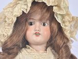 a close up of a doll wearing a hat and dress