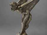 a bronze statue of a woman with wings on a pedestal