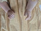 a close up of a woman ' s hands in a dress