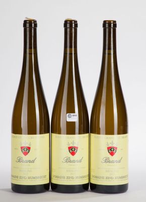 three bottles of wine sitting next to each other on a white surface