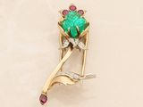 yellow gold brooch with a green stone and pink stones