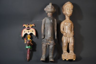 two wooden figurines of a man and a woman on a black background