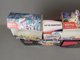 many different boxes of pokemon cards on a table