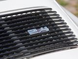 a close up of a car ' s grille with a number plate on it