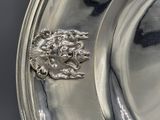 a silver plate with a lion on it on a table