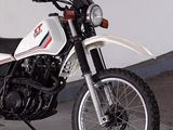 a white and red motorcycle parked in a garage