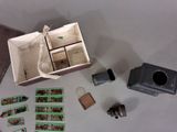a small box with a camera and some pictures on the table