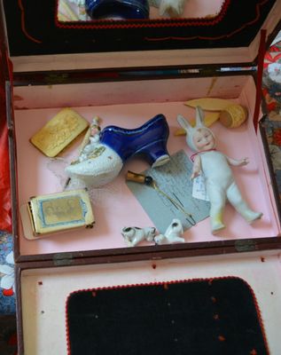 a small box with a doll in it on a table