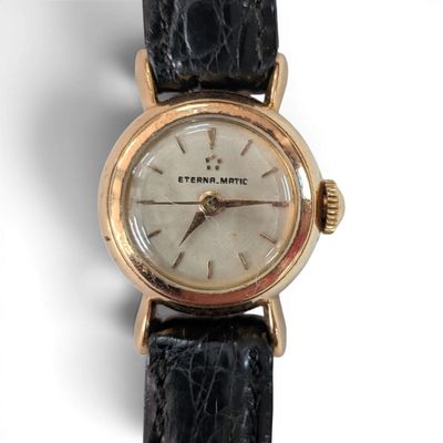 an image of a close up of a wrist watch on a white surface