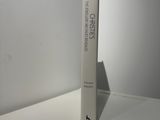 a white book sitting on a white table next to a white wall