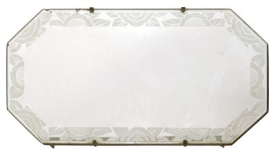 mirrored mirror with a floral design and brass frame