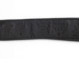 a close up of a black belt on a white background
