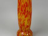 yellow and red vase on a white surface with a white background