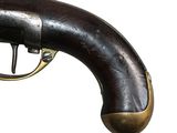 a very old gun that is on display on the wall