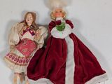 two dolls that are standing next to each other