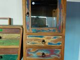 two wooden drawers and a cabinet with a mirror on top of it