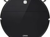 un aspirateur robot noir sur une surface blanche