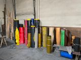 many rolls of different colored material in a room
