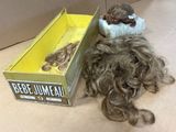 a box of hair and a stuffed animal on the floor