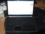 a laptop computer sitting on top of a black desk