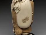 an ivory figurine of a man with a bag on his back