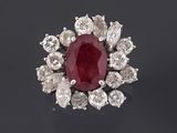 an oval ruby and diamond cluster ring