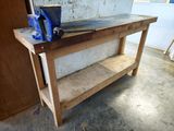 a work bench with a clamp on top of it
