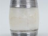 silver plated vase with white marble in it on a white surface